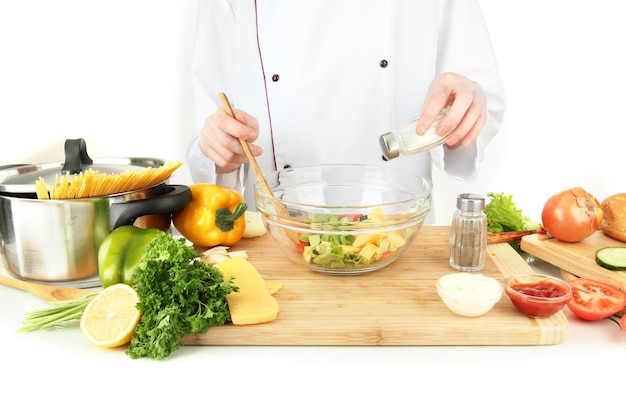 Cook preparing a meal in bright kitchen